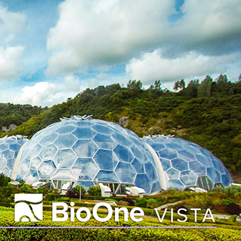 Biospheres in a lush green field at the Eden Project, Cornwall UK
