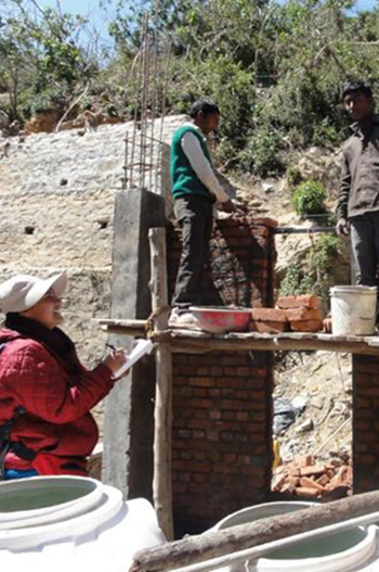 Dr Neelakshi Joshi interviews masons about risks as they build a house in Almora, India